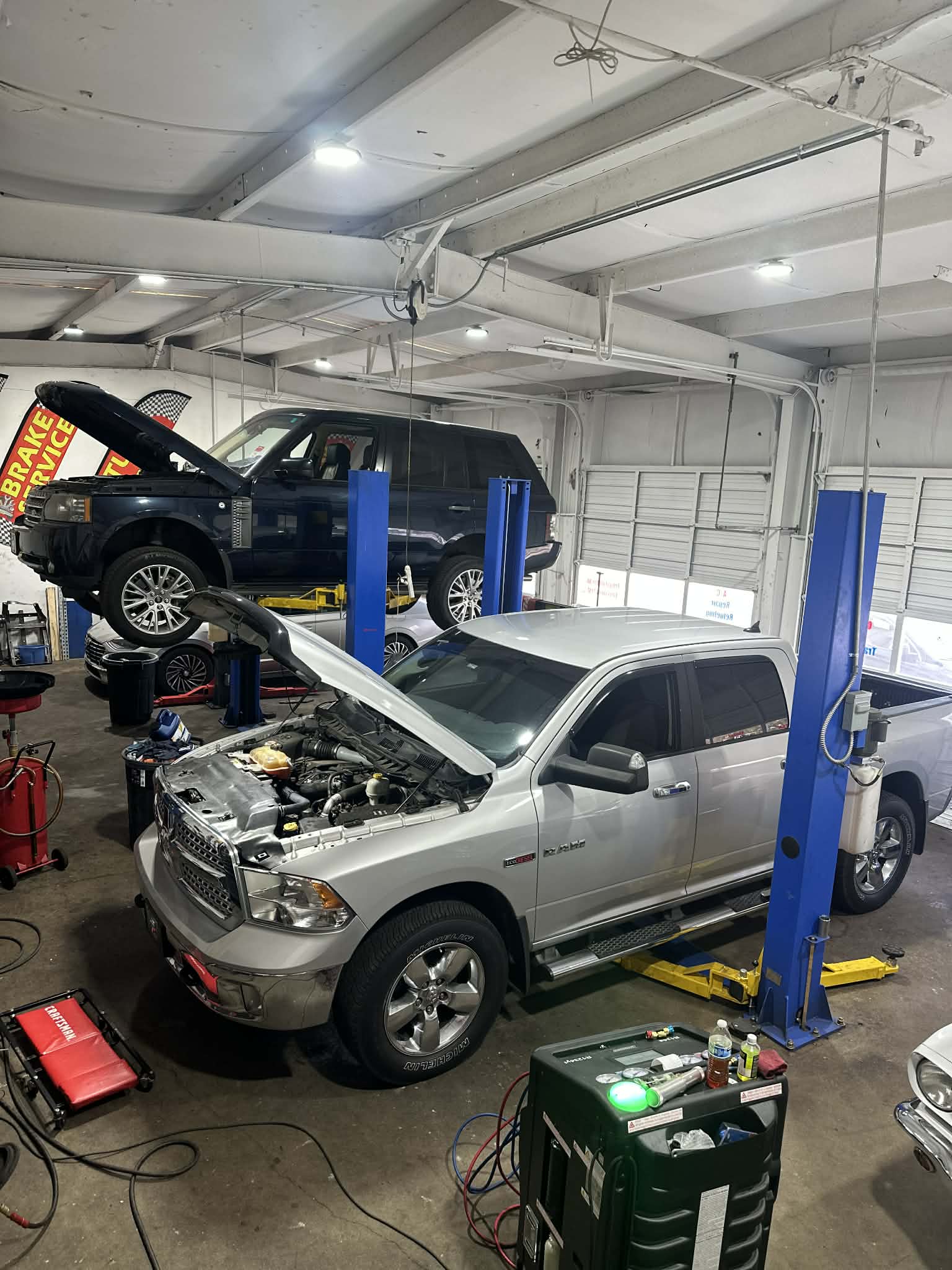 PEP Motor busy auto repair shop with multiple cars being serviced in Raleigh NC
