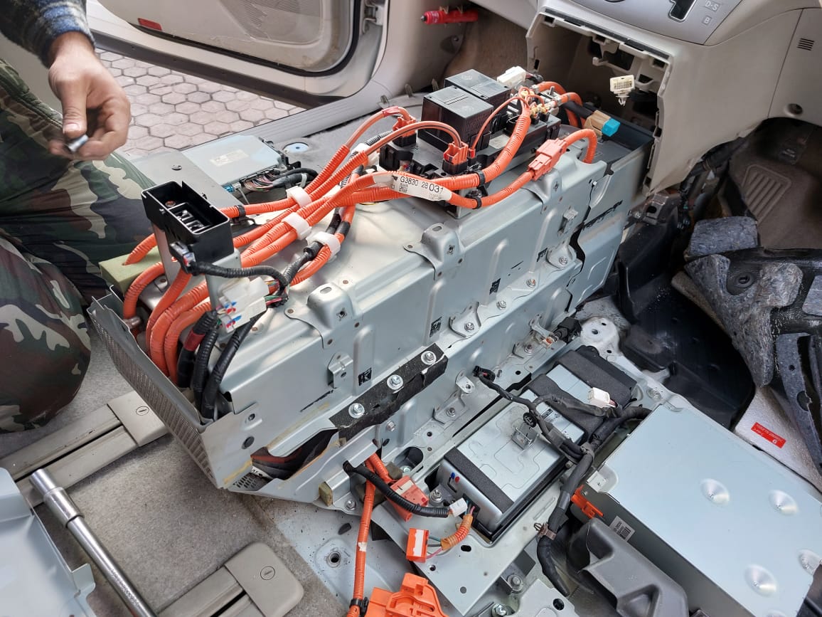 PEP Motor mechanic repairing hybrid battery pack with high-voltage wiring in Raleigh NC